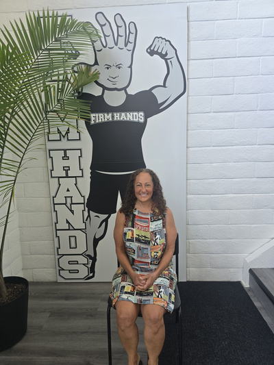A visitor seated beside the Bruce board, smiling