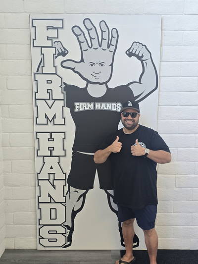 A visitor giving two thumbs up beside the Bruce board
