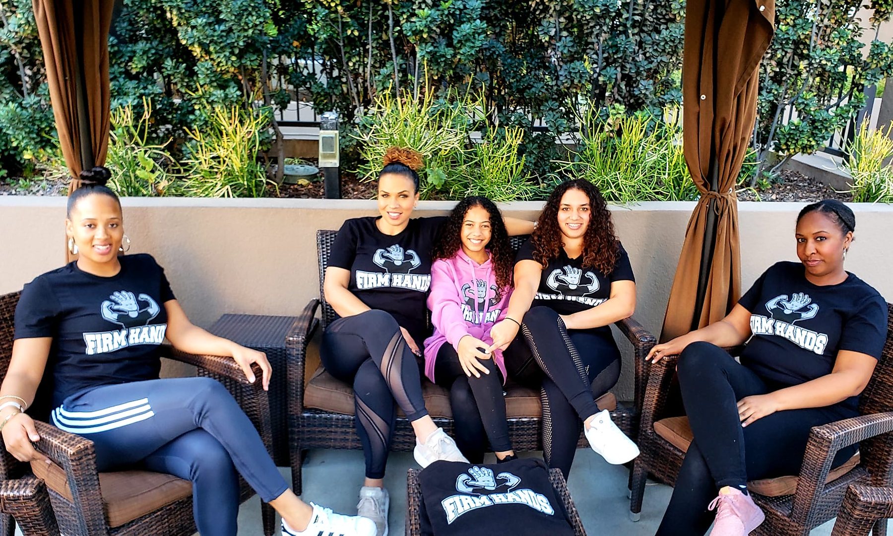 The Firm Hands team in matching shirts on the studio patio